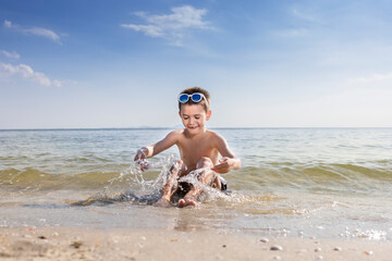 Wall Mural - Children playing water on the beach