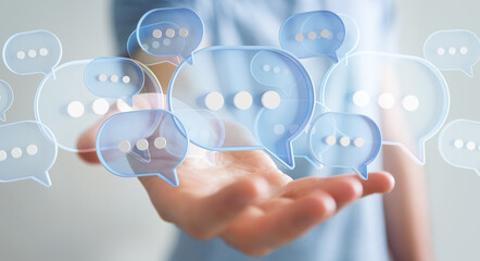 Wall Mural - Businessman using digital speech bubbles talk icons. Minimal conversation or social media messages floating over user hand. 3D rendering