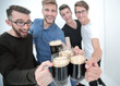 © ASDF - group of happy young men, clinking glasses of beer.