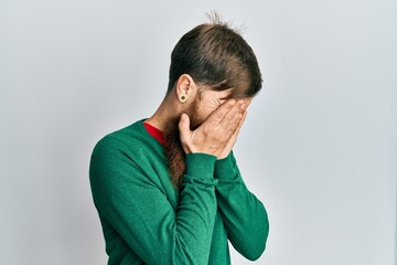 Sticker - Redhead man with long beard wearing casual clothes with sad expression covering face with hands while crying. depression concept.