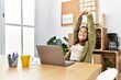 © Krakenimages.com - Young hispanic woman smiling confident stretching arms at office