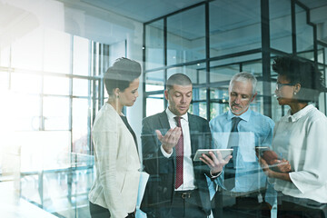 Poster - I just need some advice to help me to decide.... Shot of a business team using a digital tablet while having an informal meeting.