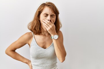 Wall Mural - Beautiful caucasian woman standing over isolated background bored yawning tired covering mouth with hand. restless and sleepiness.