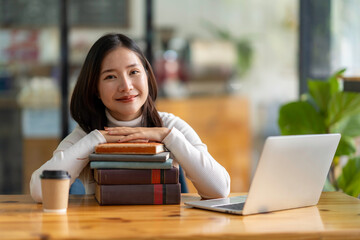 Education study abroad, Asian student girl look at laptop while doing homework making video call abroad using internet friend connection, businesswomen use computer analysis finance data