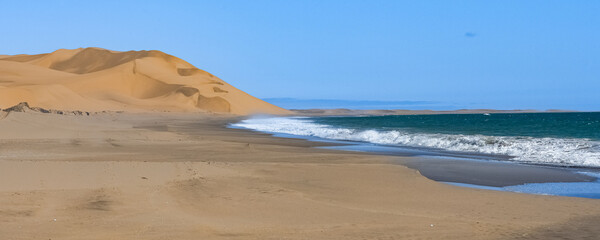 Wall Mural - Namibia, the Namib desert, dunes falling into the sea