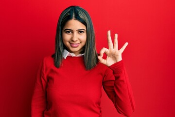 Poster - Young latin woman wearing casual clothes smiling positive doing ok sign with hand and fingers. successful expression.