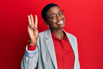 Sticker - Young african american woman wearing business jacket and glasses showing and pointing up with fingers number three while smiling confident and happy.