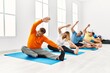 © Krakenimages.com - Group of middle age people concentrate  training yoga at sport center.
