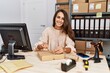 © Krakenimages.com - Young hispanic woman smiling confident packing order at storehouse
