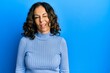 © Krakenimages.com - Middle age hispanic woman wearing casual clothes winking looking at the camera with sexy expression, cheerful and happy face.