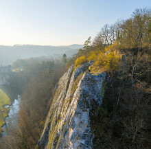 Aerial View Of A Woman Standing On The Rocks With Walzin Castle In Background At Sunset, Dinant, Namur, Belgium.