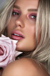Vertical closeup shot of a pretty young Caucasian woman with blonde hair and light makeup