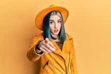 Young Modern Girl Wearing Yellow Hat And Leather Jacket Pointing Displeased And Frustrated To The Camera, Angry And Furious With You
