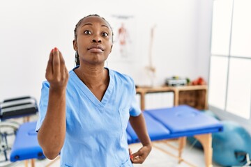 Sticker - Black woman with braids working at pain recovery clinic doing italian gesture with hand and fingers confident expression