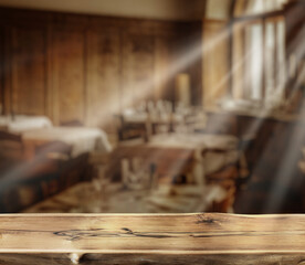 Wall Mural - Old wooden table top and blurred cafe interior at the background. Empty table and free space for any product placement and advertising.
