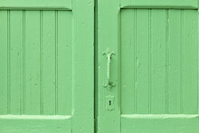 Closeup Shot Of Old Grunge Green Door With Metal Handle