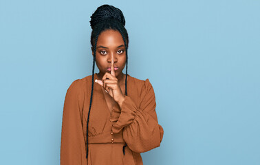 Poster - Young african american woman wearing casual clothes asking to be quiet with finger on lips. silence and secret concept.