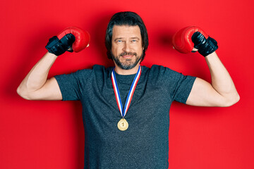 Sticker - Middle age caucasian man wearing first place medal on boxing competition relaxed with serious expression on face. simple and natural looking at the camera.