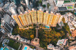 © AmazingAerialAgency - Hong Kong - 13 March 2022: Aerial View of a residential building at Sunset in Hong Kong Island.