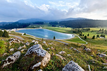 Coe Pass: The Lake And The Meadows Used For Grazing. Folgaria, Cimbra Alp, Trentino, Italy.