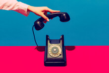 Retro Objects, Gadgets. Female Hand Holding Handset Of Vintage Phone Isolated On Blue And Pink Background. Vintage, Retro Fashion Style. Pop Art Photography.