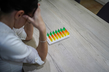 young woman preparing medication at home at the table exhausted, tired