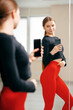 Fit woman in sportswear take photo selfie on phone in mirror