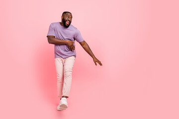 Wall Mural - Photo of pretty sweet guy wear purple t-shirt dancing empty space isolated pink color background