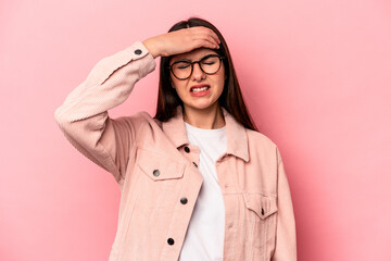 Wall Mural - Young caucasian woman isolated on pink background touching temples and having headache.