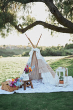 Beautiful Teepee Picnic Set Up With Flowers In A Park