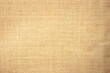 Jute hessian sackcloth burlap canvas woven texture background pattern in light beige cream brown color blank. Natural weaving fiber linen and cotton cloth texture as clean empty for decoration.