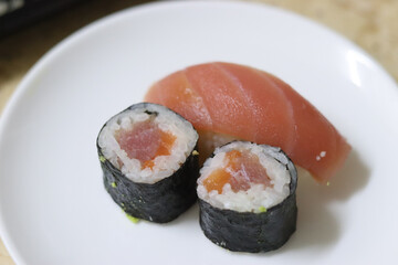 Closeup shot of the two pieces of sushi and nigiri on a white plate