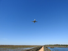 Beautiful Shot Of A Plane Flying Over Ria Formosa Park In Portugalvin The Blue Sky