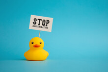 Rubber Duck Carries A Signboard With The Word Stop Discrimination. Political Activism Against Discrimination