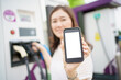 © DG PhotoStock - Empty screen of mockup smartphone isolated with clipping path. Asian young woman using ev charging application on smartphone.