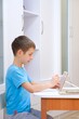 © Елена Коломиец - Boy of primary school age studies, draws on a tablet with wireless stylus. Crafting. Creativity. Kids using technology. Preparation for school. Classes for children of preschool and primary school age