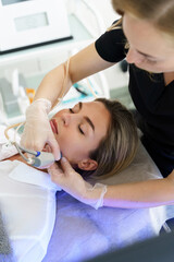 Poster - Woman during deep facial cleansing in a cosmetology clinic