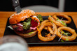 © Prins Productions - Friends out for dinner eating delicious juicy vegetarian burger