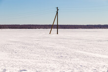 Power Pole In A Field In Winter