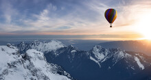 Dramatic Mountain Landscape Covered In Clouds And Hot Air Balloon Flying.