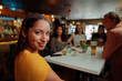 © Prins Productions - diverse women smiling while out for dinner with friends