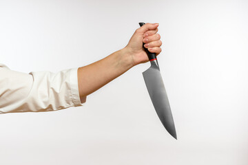 large kitchen knife in a female hand close-up on a white background