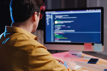 back view young student software male engineer it specialist man in shirt work at home writing code 