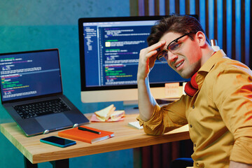 side view young confused sad software engineer it specialist programmer man in shirt work at home wr