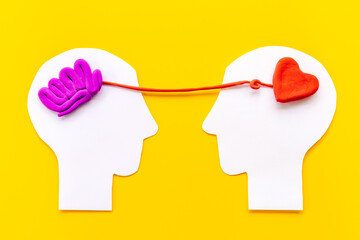 Wall Mural - Brain and heart - logic and emotion. Communication between two paper human heads