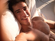 © theartofphoto - Attractive young man using cell phone to take selfie photo