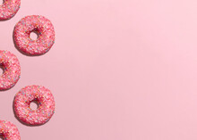 Donuts. Design Template With Copy Space. Pink Glazed Doughnuts With Sprinkles On Pink Background