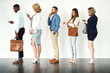 © Arnéll Koegelenberg/peopleimages.com - Theyre ready to get going. Studio shot of a group o focused people standing in a row behind each other against a white background.