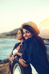 Sticker - This road trip was just what we needed to chill. Shot of two young friends stopping at the beach during their roadtrip.