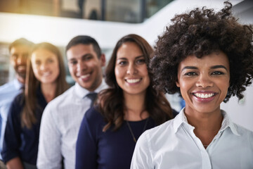Poster - Smiles won through success. Portrait of a team of happy businesspeople standing behind each other in the office.